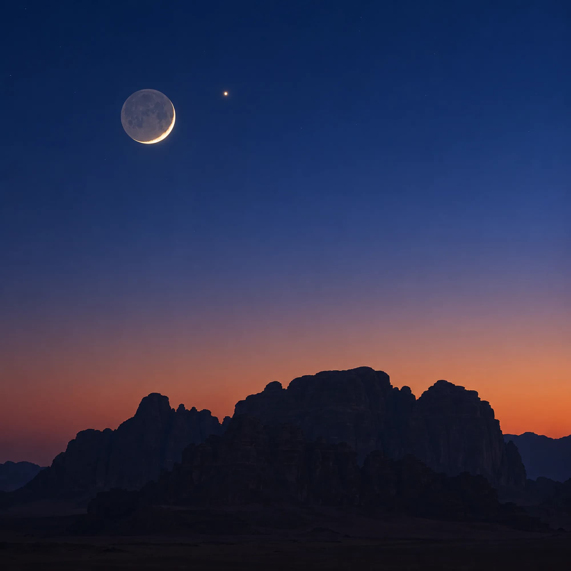 A thin crescent moon above a dark sandstone ridge in a deep blue dusk sky